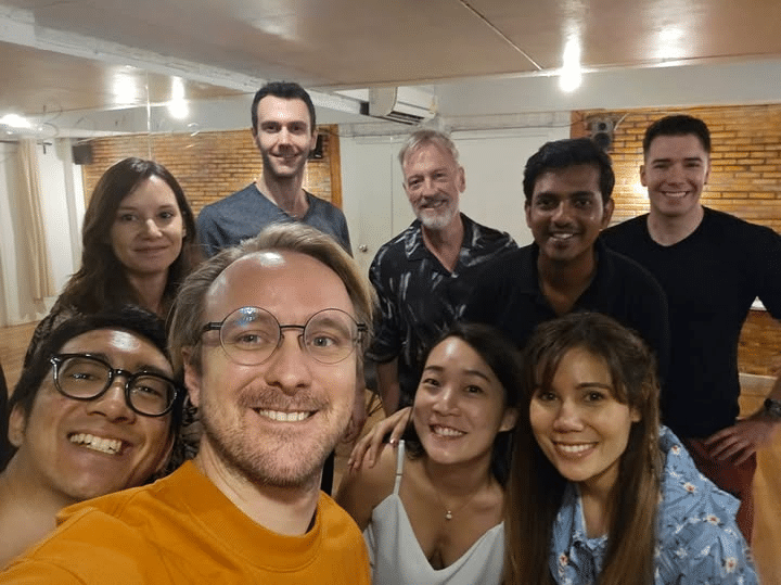Diverse group of actors on a Bangkok film set, collaborating and showcasing diversity.  

