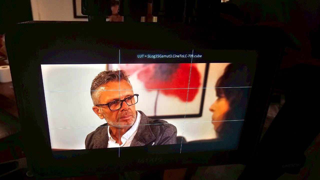 Multicultural actor rehearsing lines on a Bangkok film set, highlighting professionalism.  

