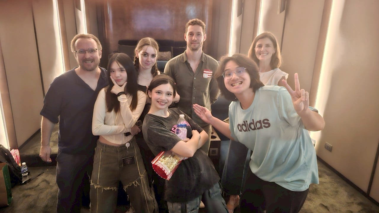 Bustling film set in Thailand with actors and crew collaborating, showcasing the industry’s energy.
