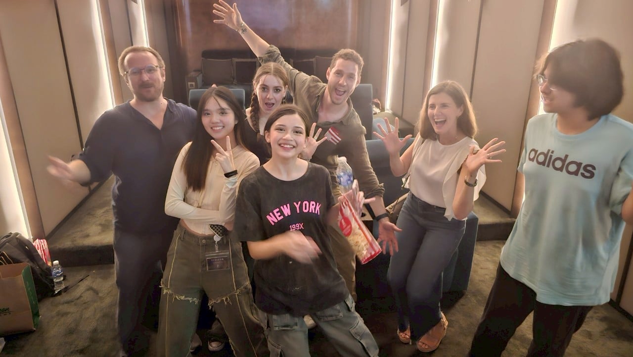 Bustling film set in Thailand with actors and crew collaborating, showcasing the industry’s energy.

