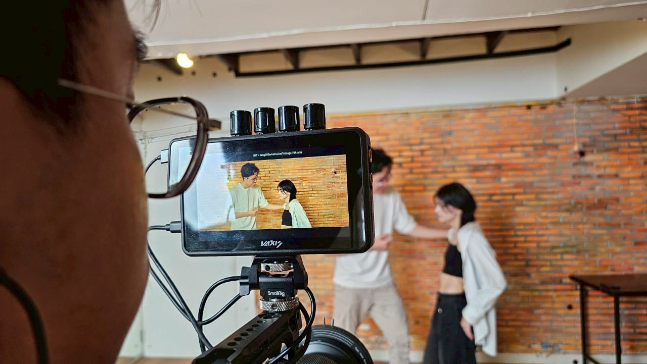 Thailand commercial set with models filming a vibrant ad, showcasing campaign energy.  

